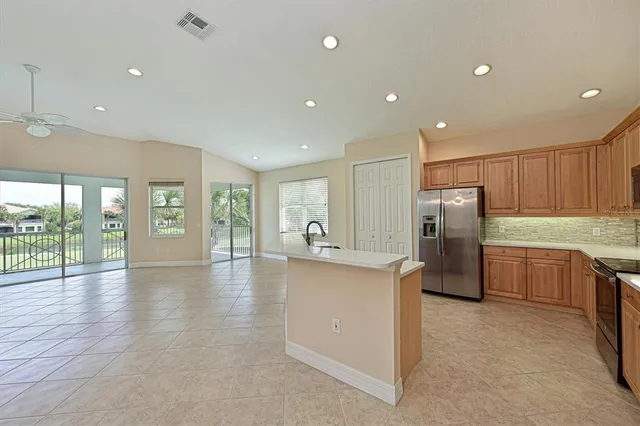 a view of a kitchen with refrigerator and wooden floor