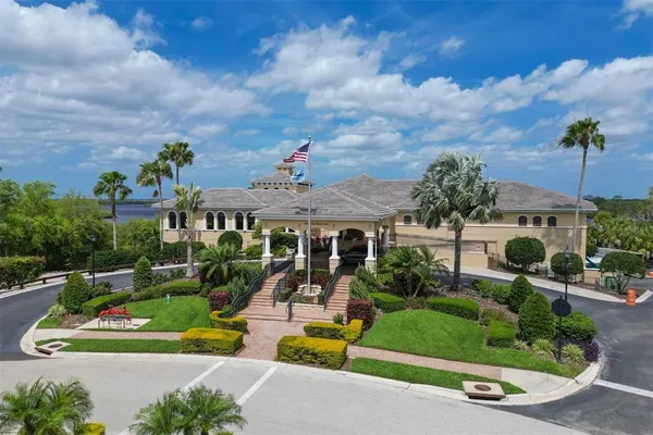 an aerial view of a house with a garden and lake view