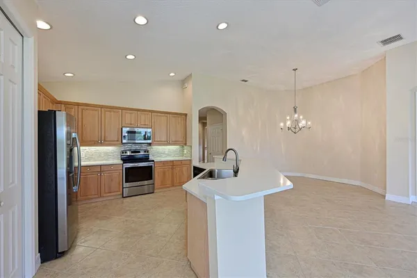 a kitchen with kitchen island a sink stainless steel appliances and cabinets