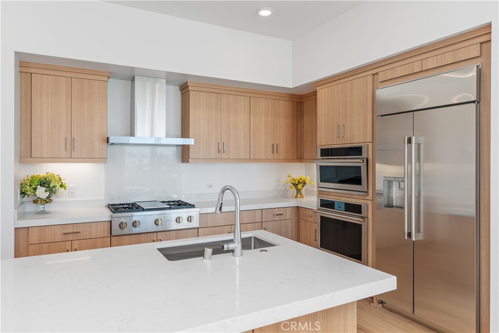 1601 Rivington Irvine, CA 92612 - Photo 11 of 29 a kitchen with a refrigerator a stove a sink and a counter