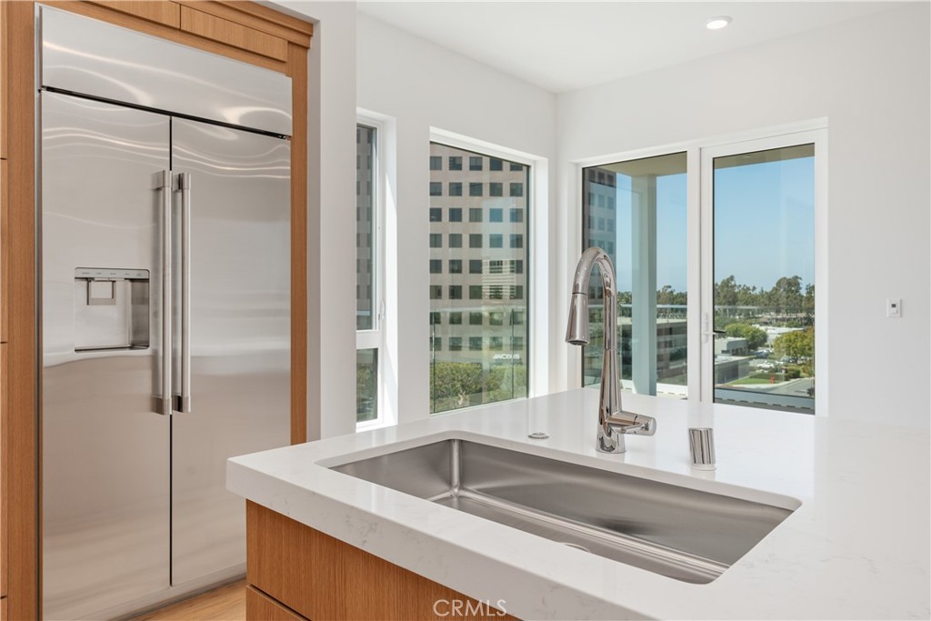 1601 Rivington Irvine, CA 92612 - Photo 13 of 29 a kitchen with a refrigerator sink and cabinets