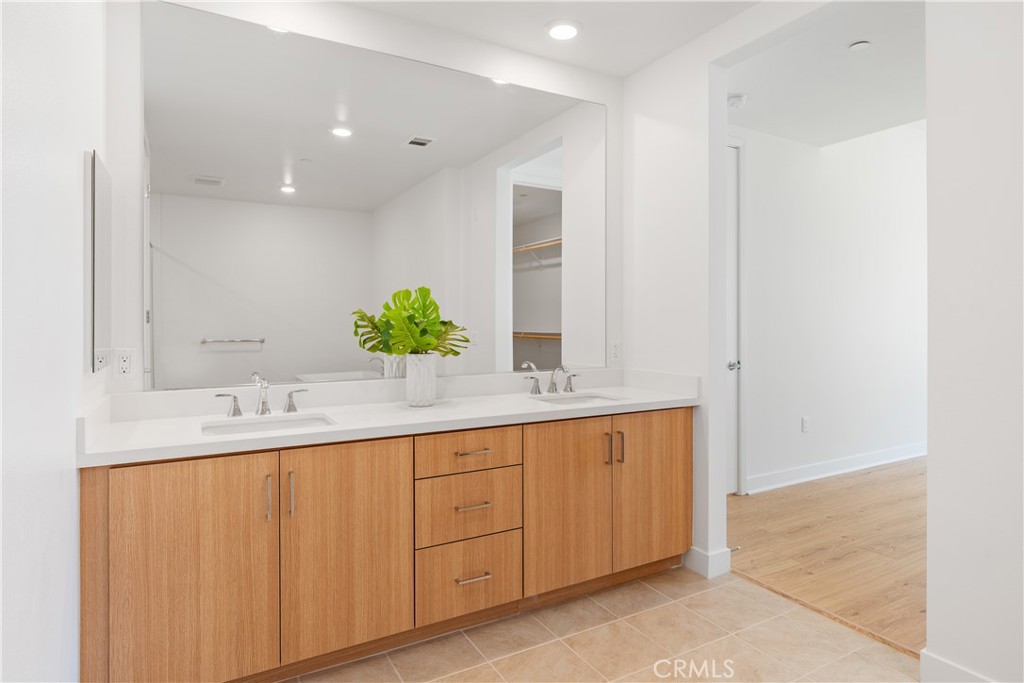 1601 Rivington Irvine, CA 92612 - Photo 17 of 29 a bathroom with a double vanity sink and a mirror