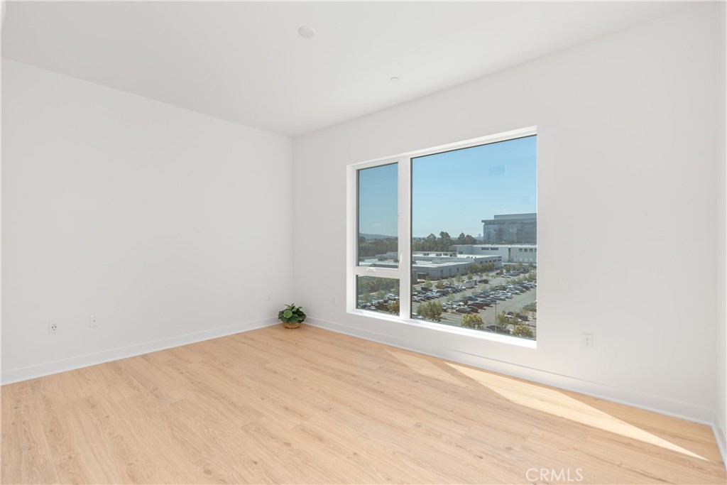 1601 Rivington Irvine, CA 92612 - Photo 21 of 29 an empty room with wooden floor and a window