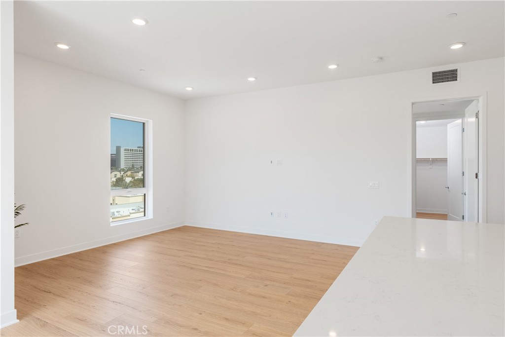 1601 Rivington Irvine, CA 92612 - Photo 7 of 29 an empty room with wooden floor and windows