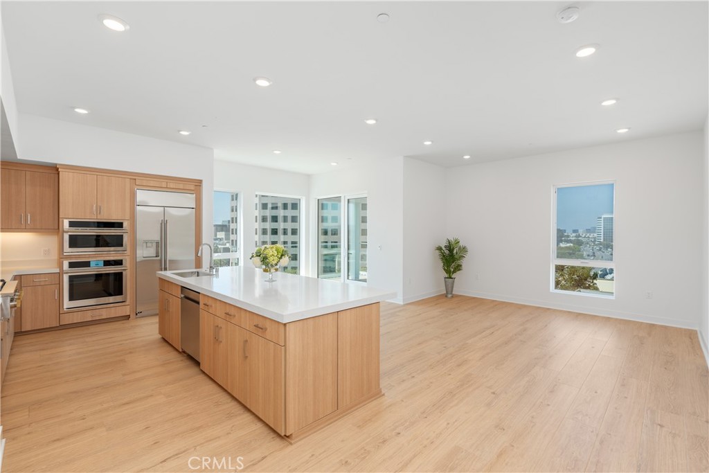 1601 Rivington Irvine, CA 92612 - Photo 9 of 29 a large kitchen with stainless steel appliances granite countertop a large counter top and a wooden floors