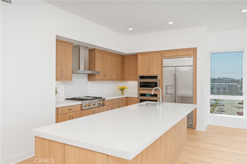 1601 Rivington Irvine, CA 92612 - Photo 10 of 29 a kitchen with granite countertop a stove a sink and a refrigerator