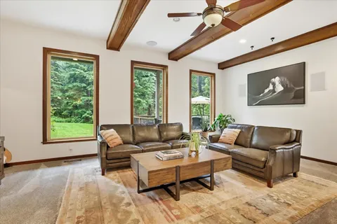 a kitchen with stainless steel appliances granite countertop a table chairs sink and cabinets