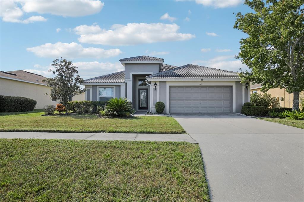 a front view of a house with a garden