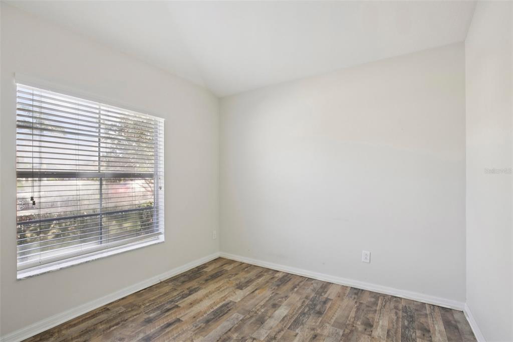 106 Star Shell Drive Apollo Beach, FL 33572 - Photo 14 of 33 a view of an empty room with wooden floor and a window