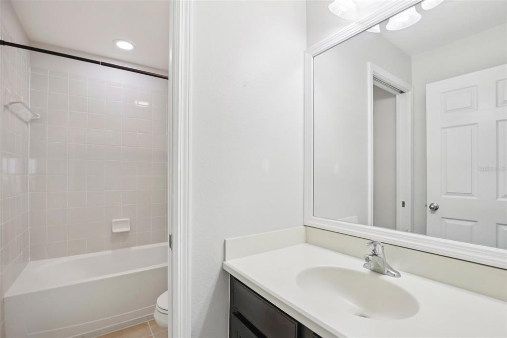 106 Star Shell Drive Apollo Beach, FL 33572 - Photo 20 of 33 a bathroom with a sink a toilet and shower