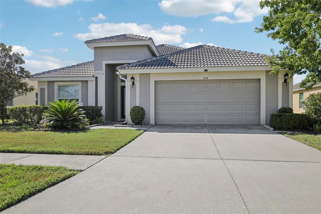 106 Star Shell Drive Apollo Beach, FL 33572 - Photo 3 of 33 a front view of a house with a garden and entryway