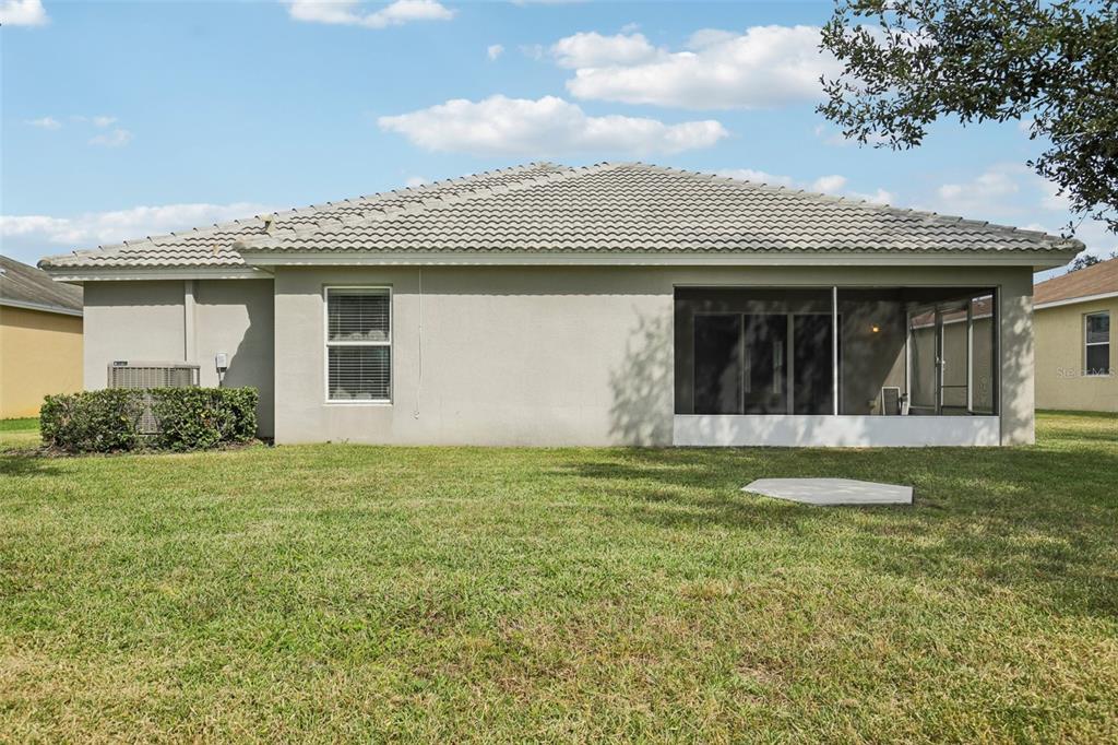 106 Star Shell Drive Apollo Beach, FL 33572 - Photo 31 of 33 a view of a white house next to a yard with potted plants