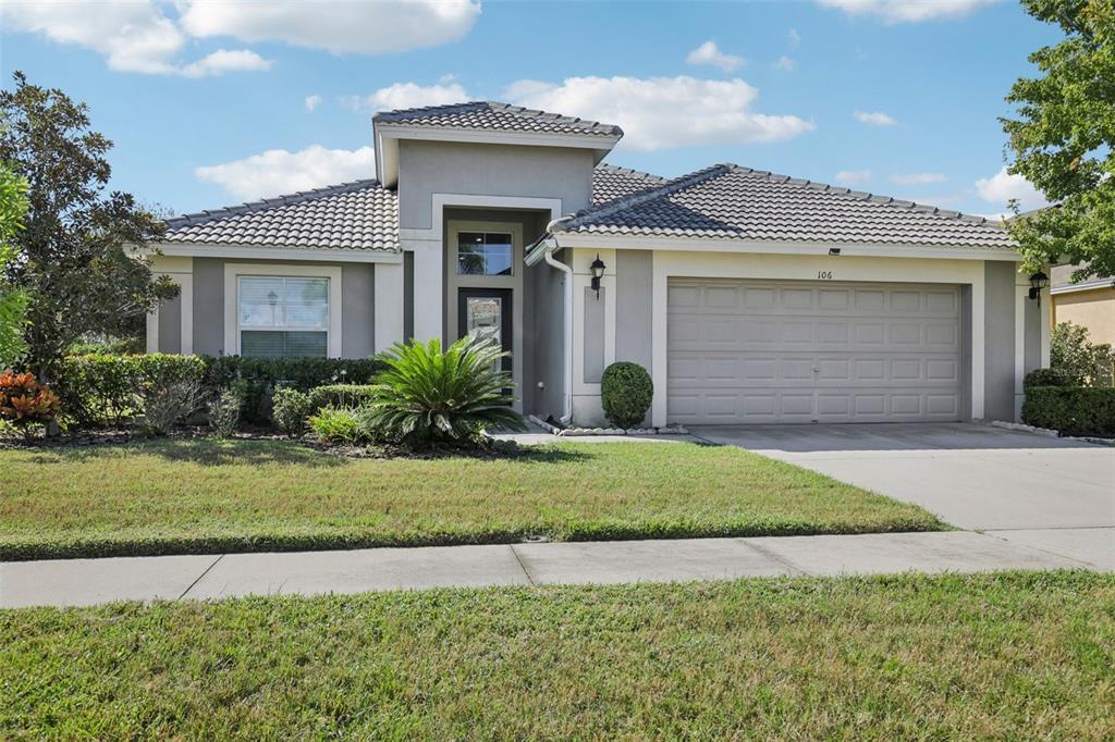 106 Star Shell Drive Apollo Beach, FL 33572 - Photo 4 of 33 a front view of a house with a garden and plants