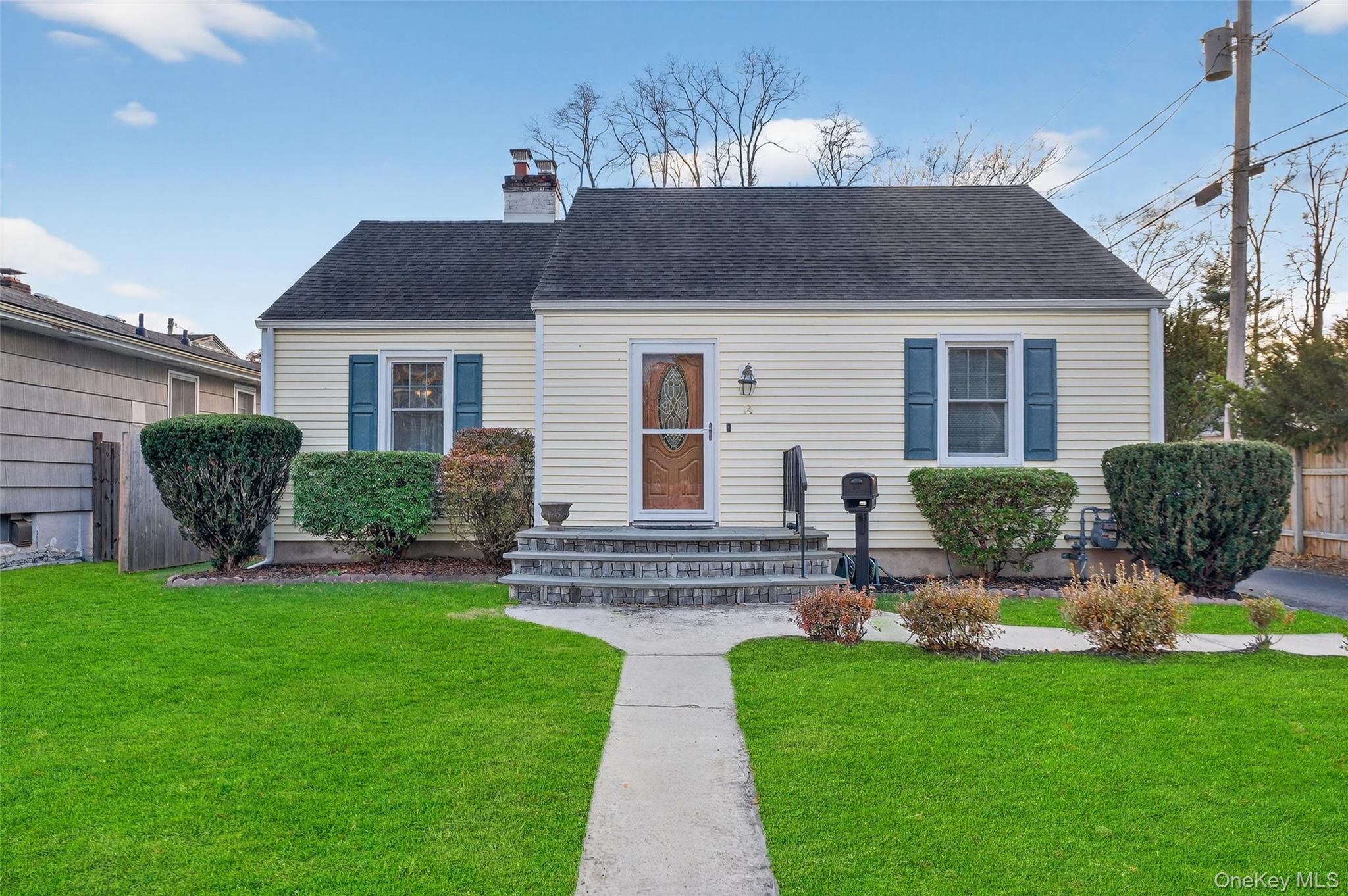 a front view of house with yard and outdoor seating