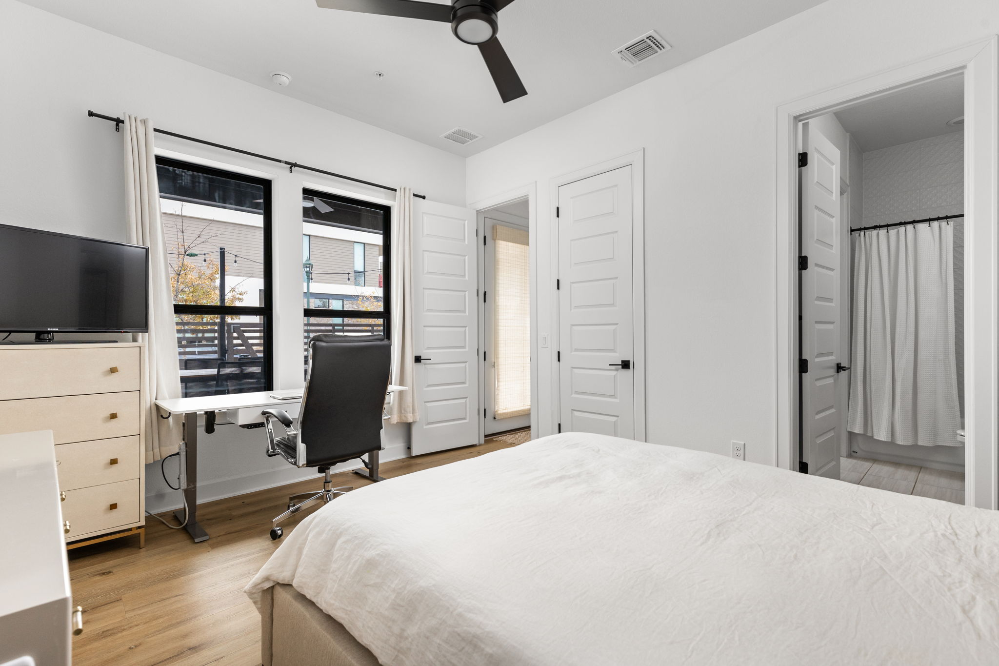 4710 Eberly Street Austin, TX 78723 - Photo 12 of 36 a bedroom with a bed and a flat screen tv