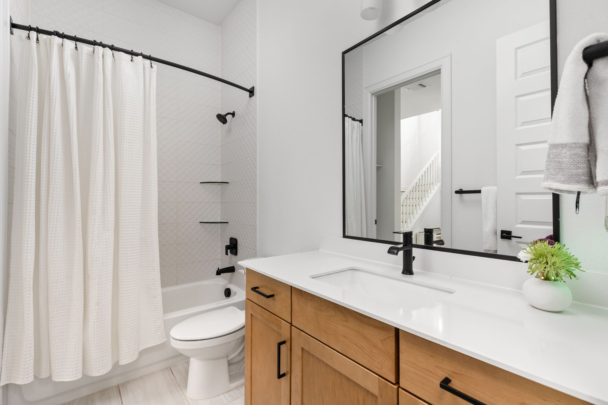 4710 Eberly Street Austin, TX 78723 - Photo 13 of 36 a bathroom with a double vanity sink toilet and shower
