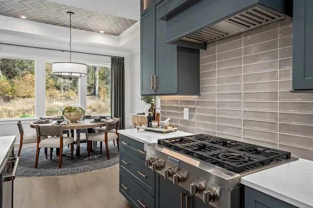 a bedroom with a bed a chandelier and a large window