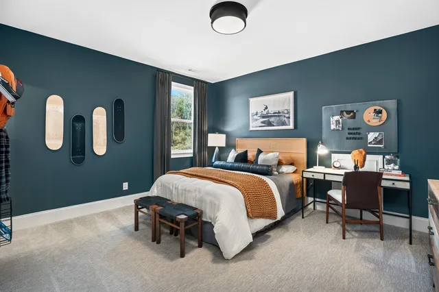 a front view of a house with a garden and plants