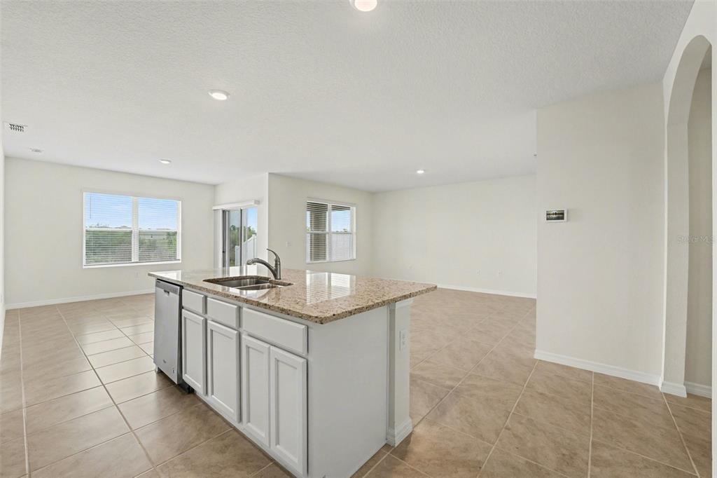 2795 Grandbury Grove Road Lakeland, FL 33811 - Photo 12 of 35 a kitchen with stainless steel appliances granite countertop a sink and cabinets