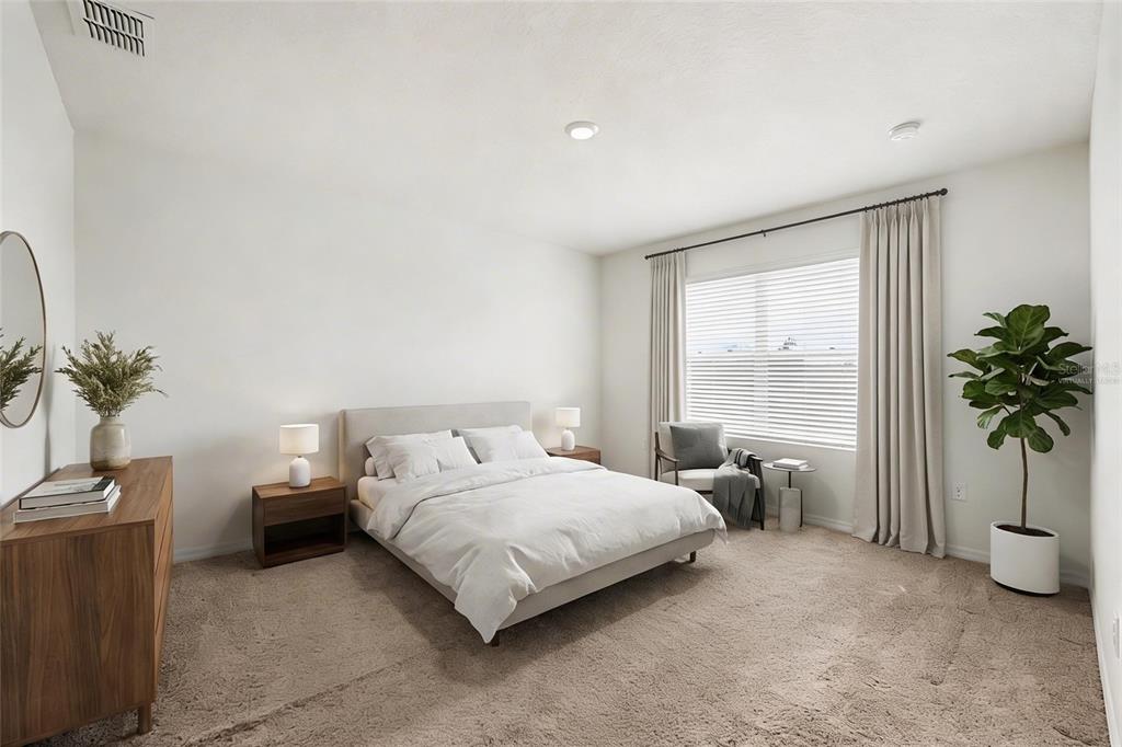 2795 Grandbury Grove Road Lakeland, FL 33811 - Photo 17 of 35 a bedroom with a bed and a potted plant