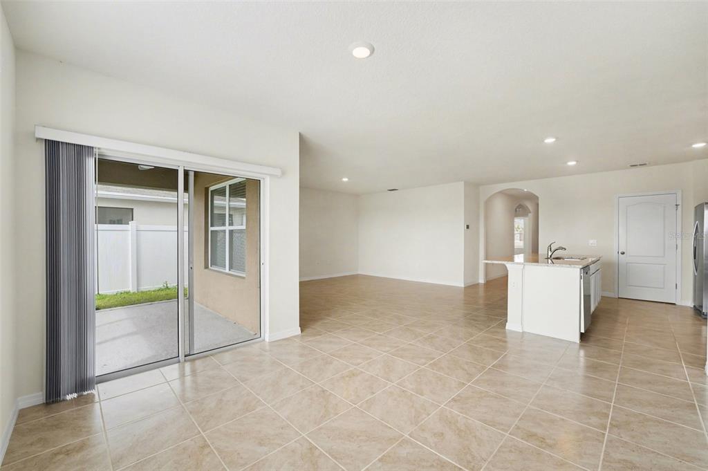 2795 Grandbury Grove Road Lakeland, FL 33811 - Photo 7 of 35 a view of an empty room with kitchen and a window