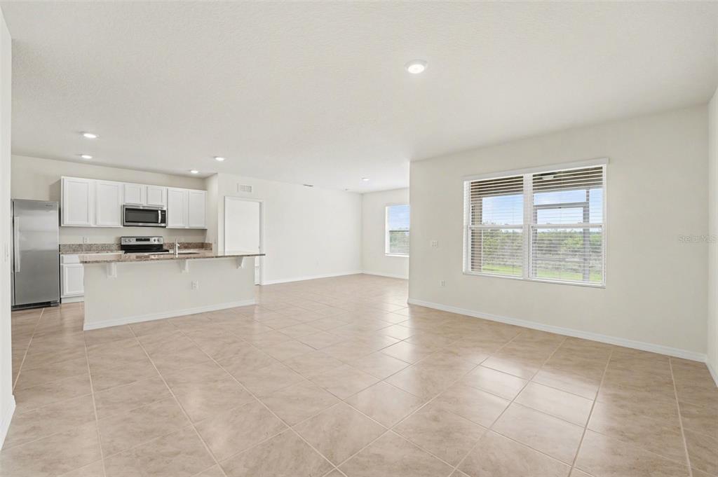2795 Grandbury Grove Road Lakeland, FL 33811 - Photo 9 of 35 a view of kitchen with kitchen island stainless steel appliances refrigerator sink and cabinets