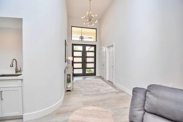 a living room with furniture a table and a large window
