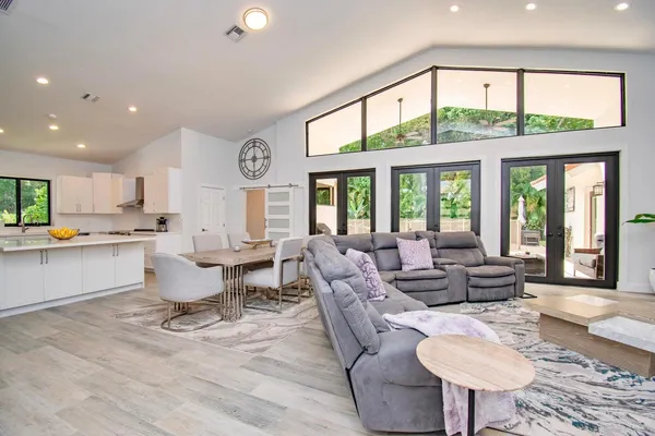 a living room with kitchen island furniture and a large window