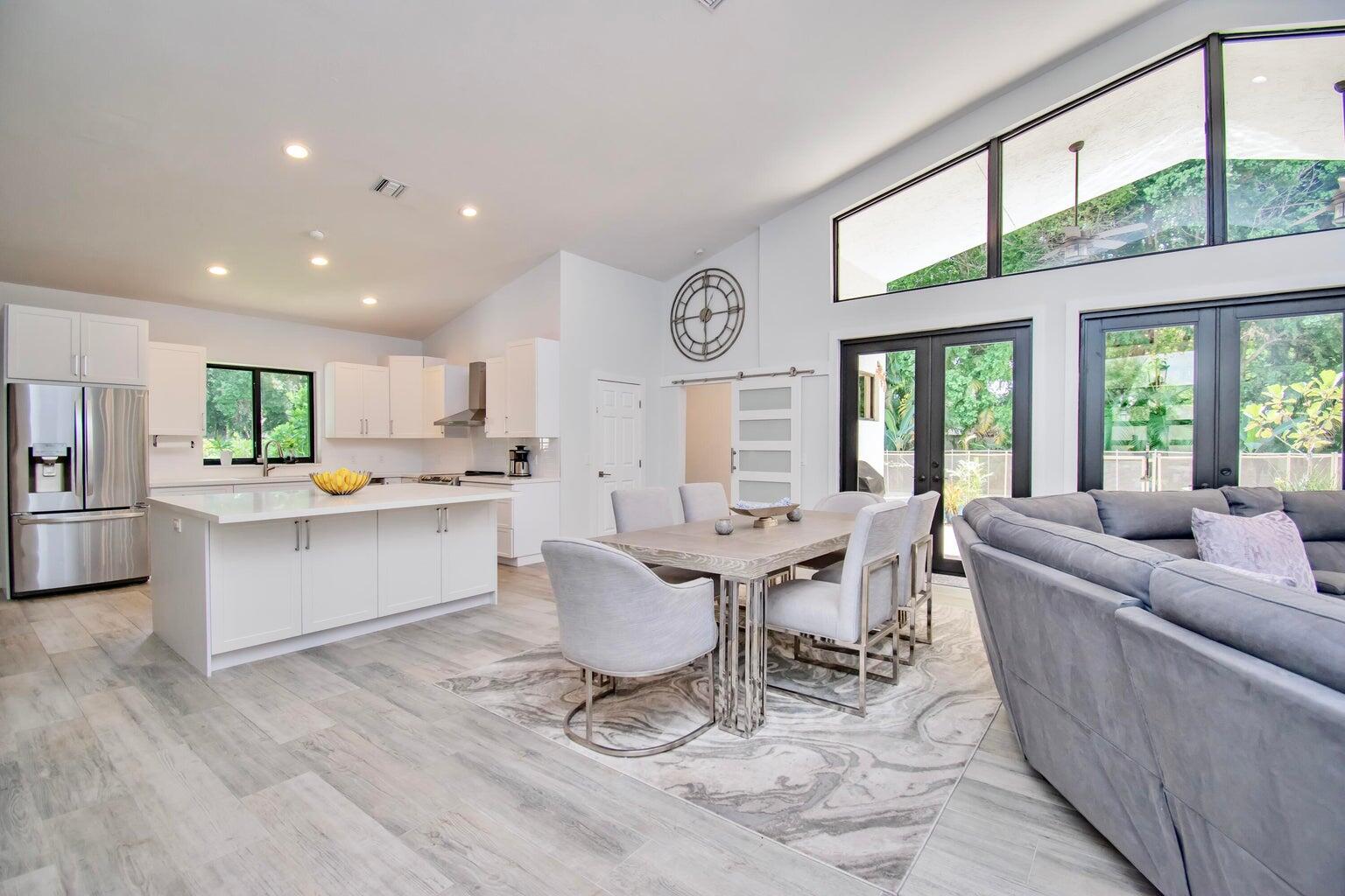 2302 Northwest 66th Drive Boca Raton, FL 33496 - Photo 14 of 53 a living room with kitchen island furniture and a large window