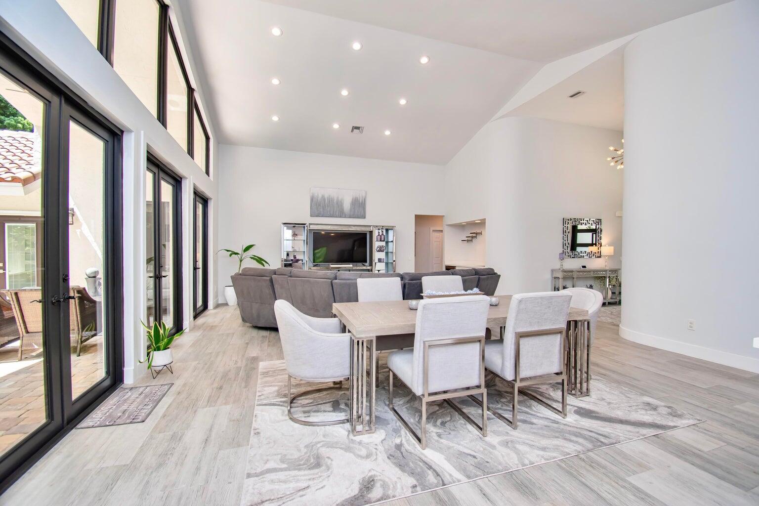 2302 Northwest 66th Drive Boca Raton, FL 33496 - Photo 16 of 53 a view of a dining room with furniture window and wooden floor
