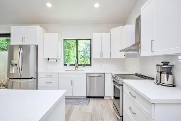 a kitchen that has a stove and a microwave