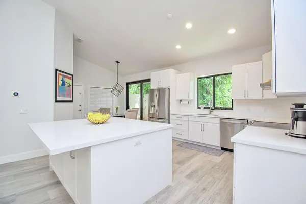 a kitchen with a sink a counter top space and stainless steel appliances