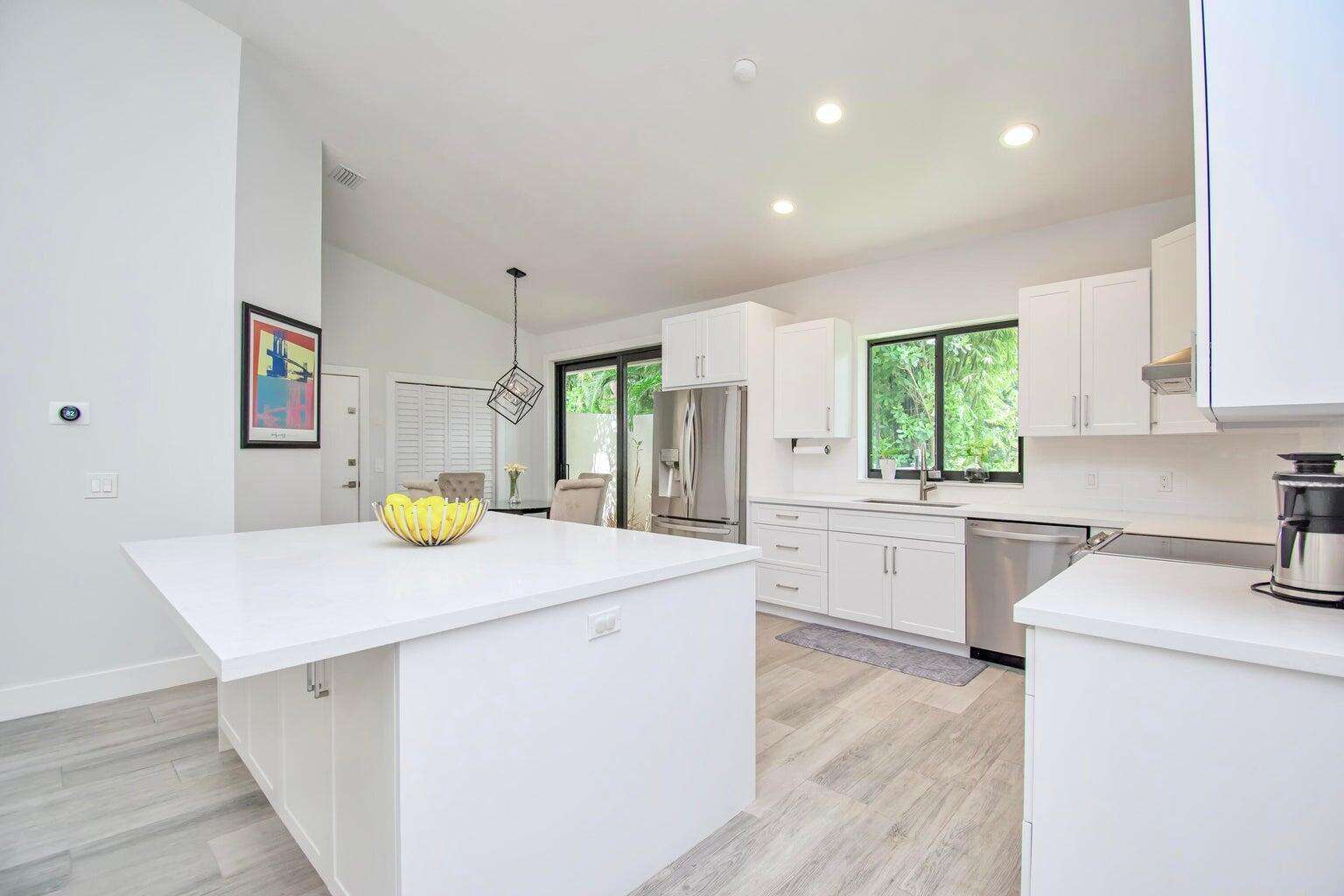 2302 Northwest 66th Drive Boca Raton, FL 33496 - Photo 23 of 53 a kitchen that has a sink stainless steel appliances and cabinets