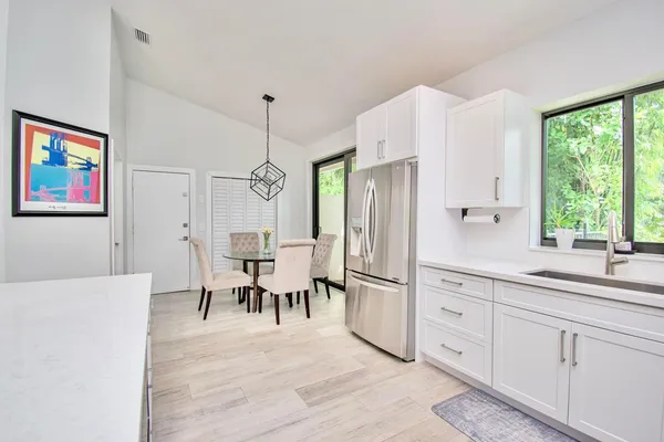 a dining room with furniture window and wooden floor