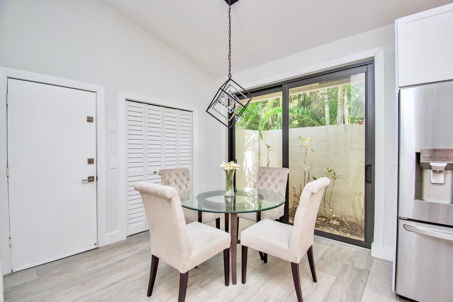 2302 Northwest 66th Drive Boca Raton, FL 33496 - Photo 26 of 53 a dining room with furniture window and wooden floor
