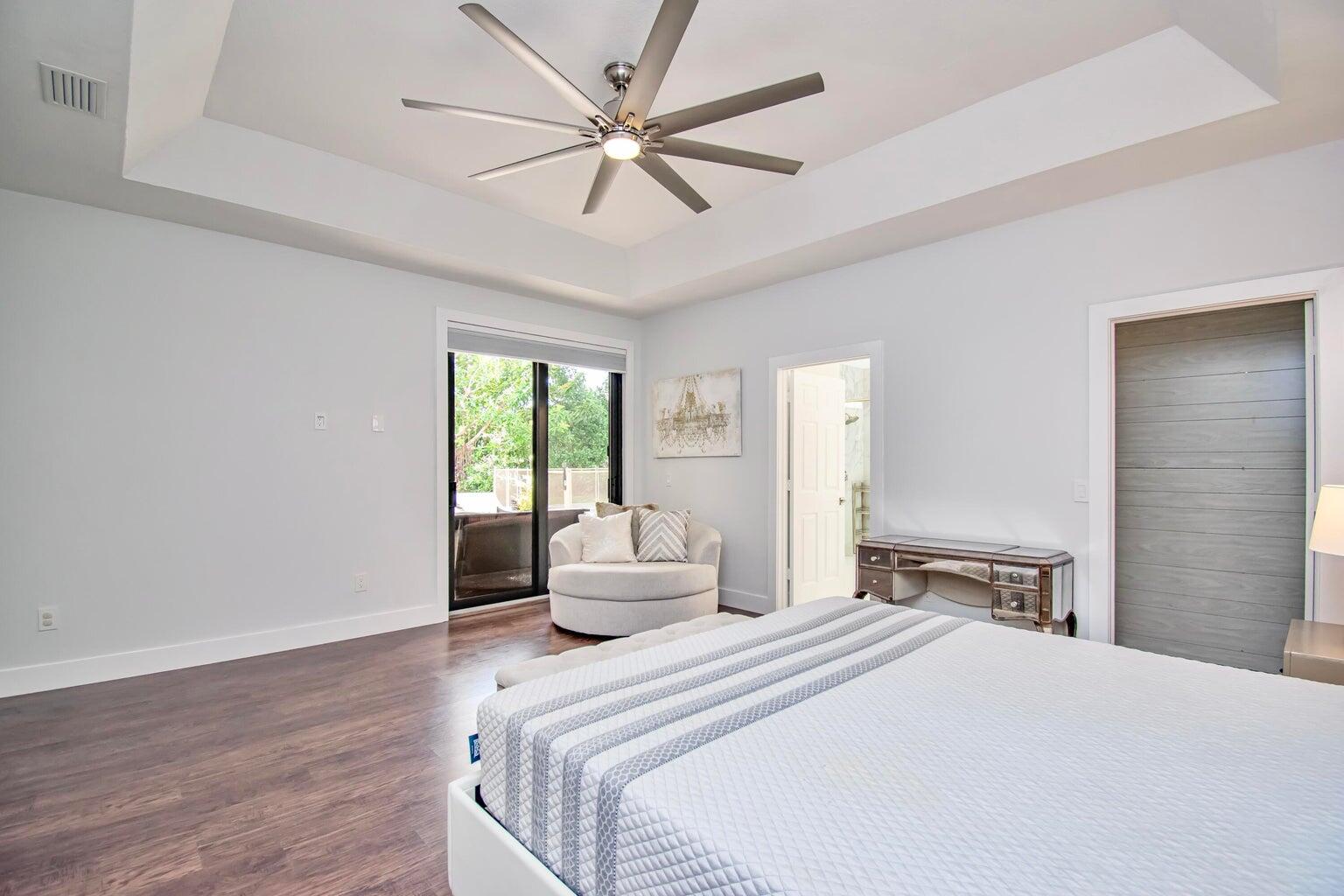 2302 Northwest 66th Drive Boca Raton, FL 33496 - Photo 29 of 53 a bedroom with a large bed and wooden floor
