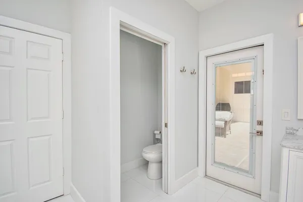 a bedroom with a bed mirror and a window