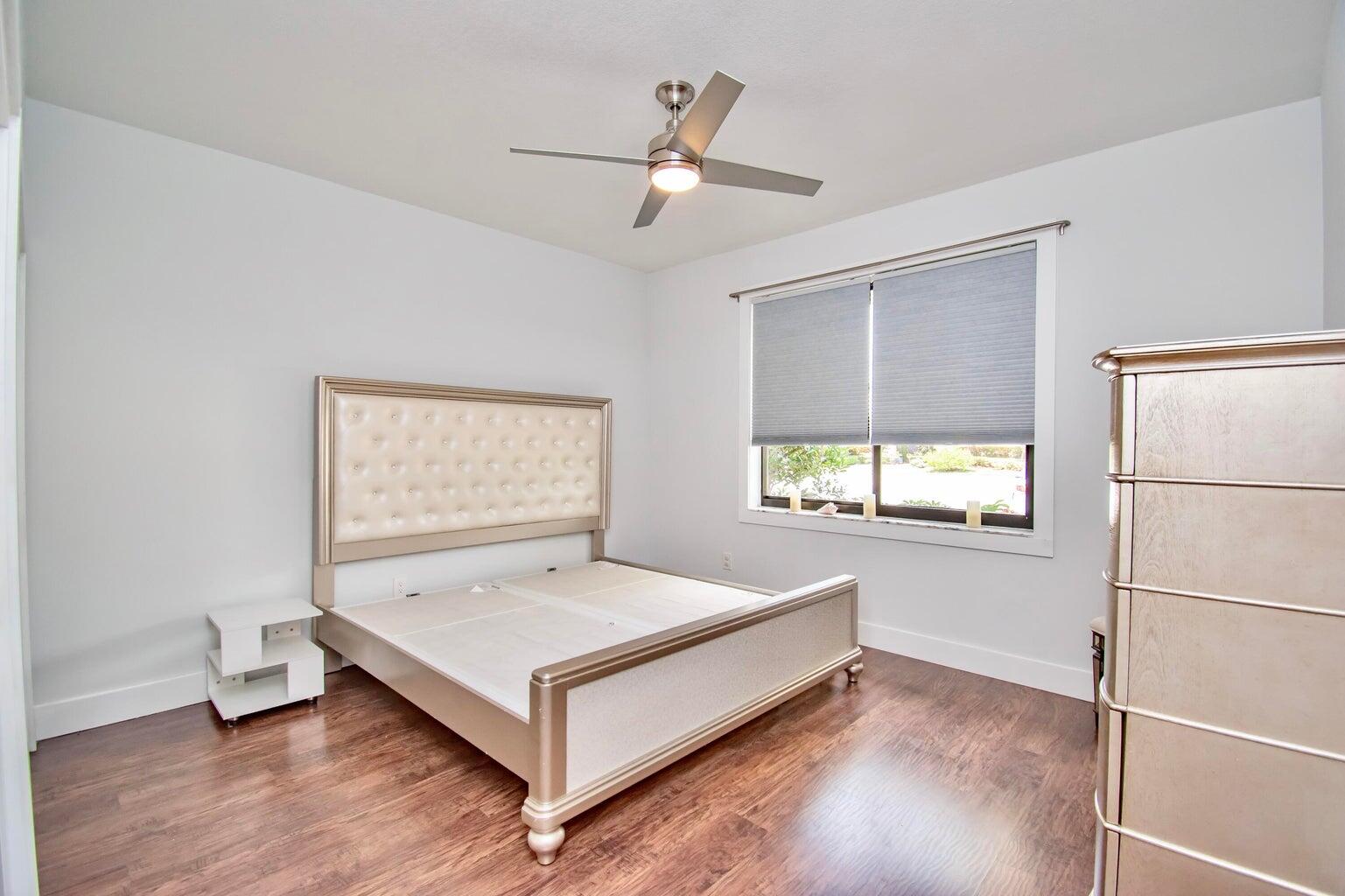 2302 Northwest 66th Drive Boca Raton, FL 33496 - Photo 37 of 53 a spacious bedroom with a bed and window