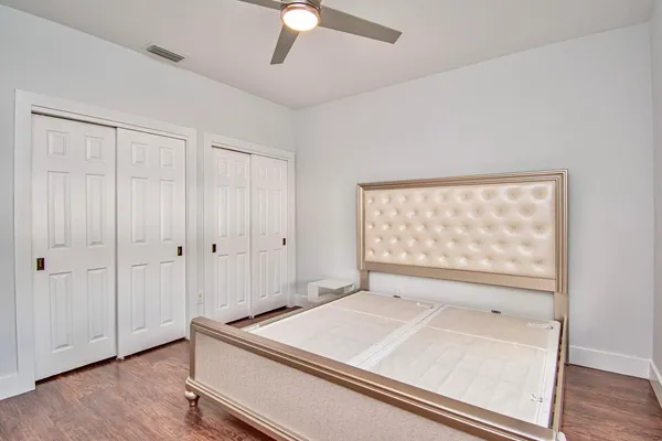 a view of a room with wooden floor white walls and a window