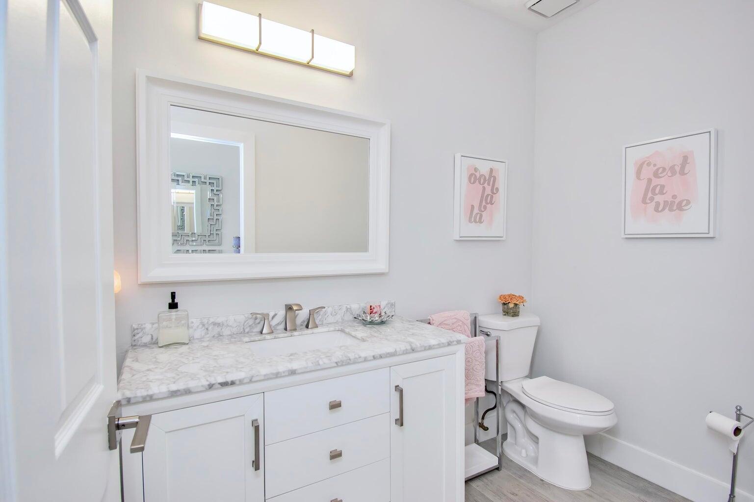 2302 Northwest 66th Drive Boca Raton, FL 33496 - Photo 40 of 53 a bathroom with a granite countertop toilet sink and mirror
