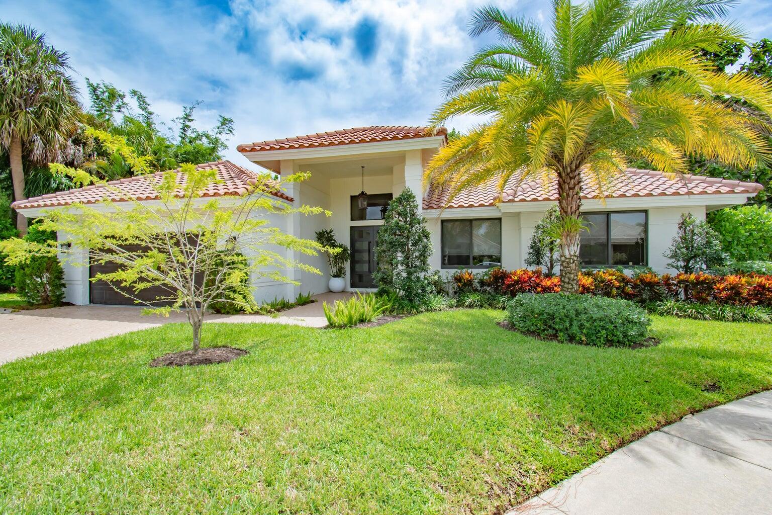 2302 Northwest 66th Drive Boca Raton, FL 33496 - Photo 4 of 53 a house with garden in front of it