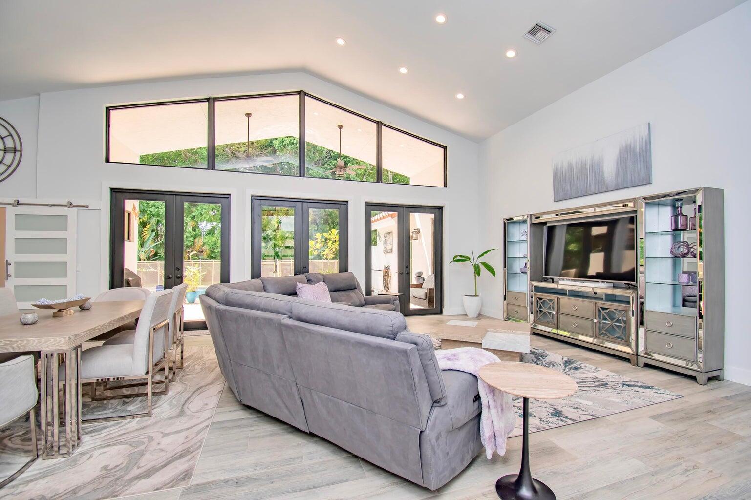 2302 Northwest 66th Drive Boca Raton, FL 33496 - Photo 6 of 53 a living room with furniture and a flat screen tv