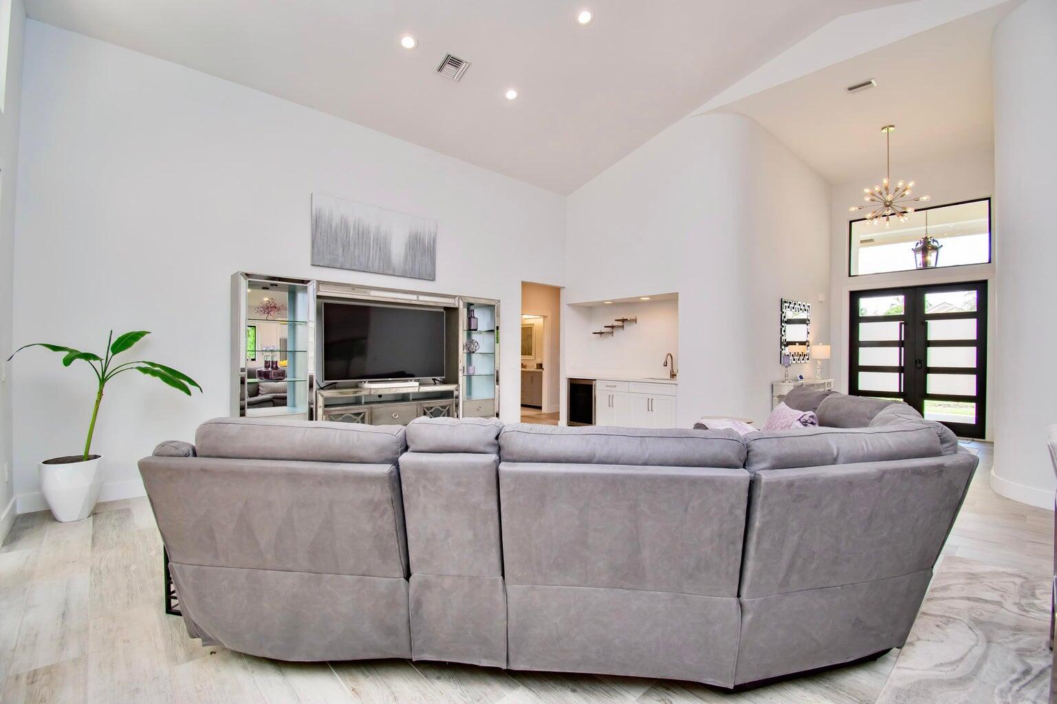 2302 Northwest 66th Drive Boca Raton, FL 33496 - Photo 9 of 53 a living room with furniture and a flat screen tv