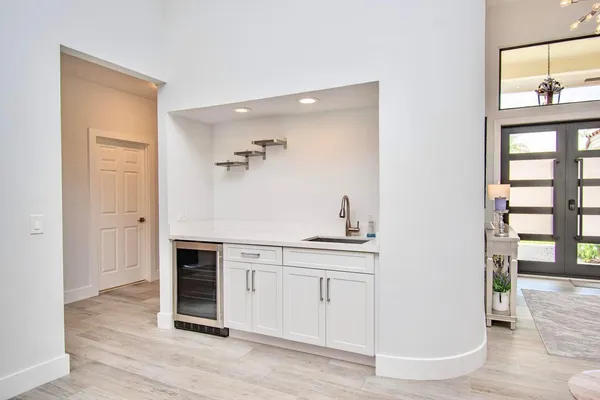 a view of a kitchen with wooden floor and electronic appliances