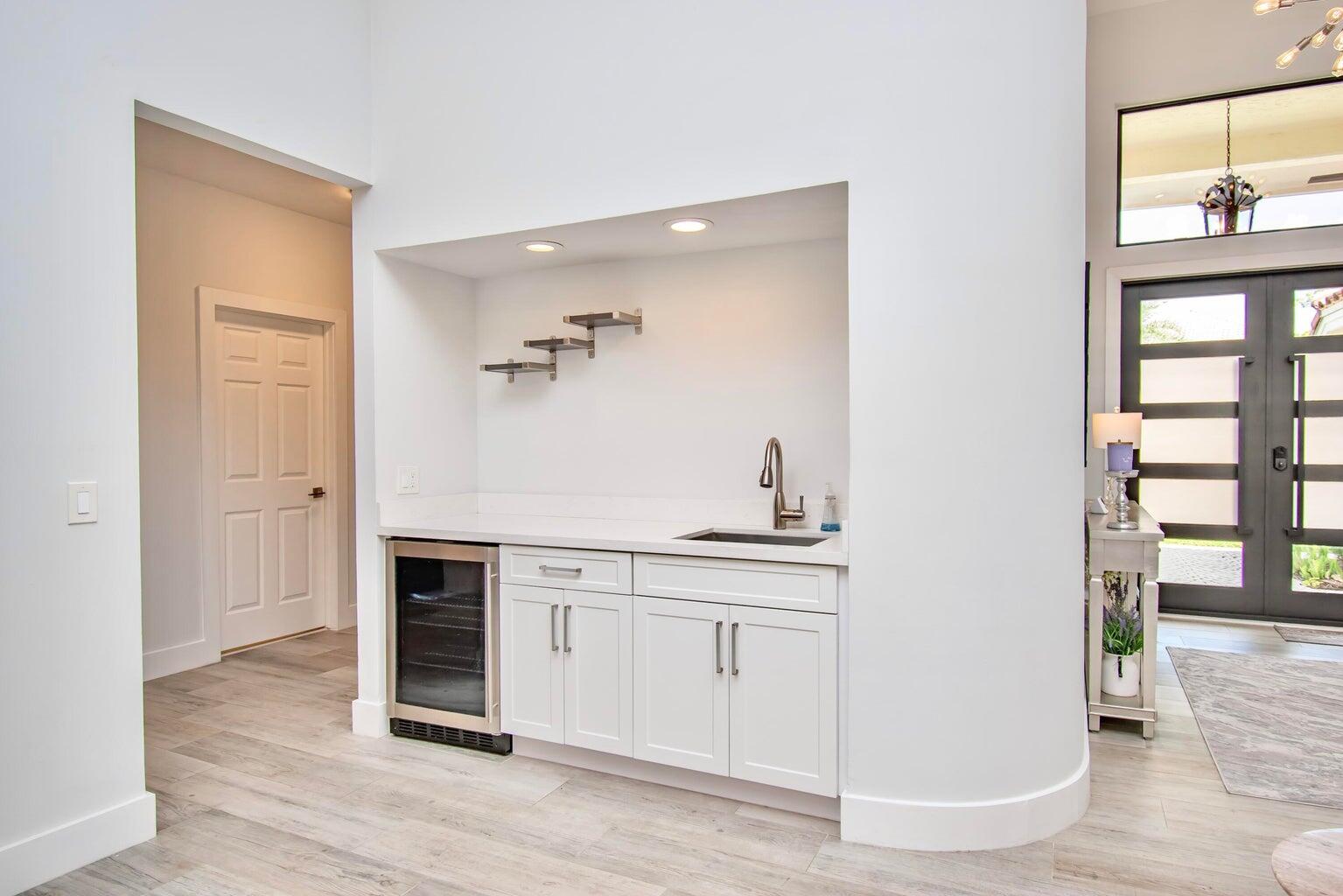 2302 Northwest 66th Drive Boca Raton, FL 33496 - Photo 10 of 53 a view of a kitchen with wooden floor and electronic appliances