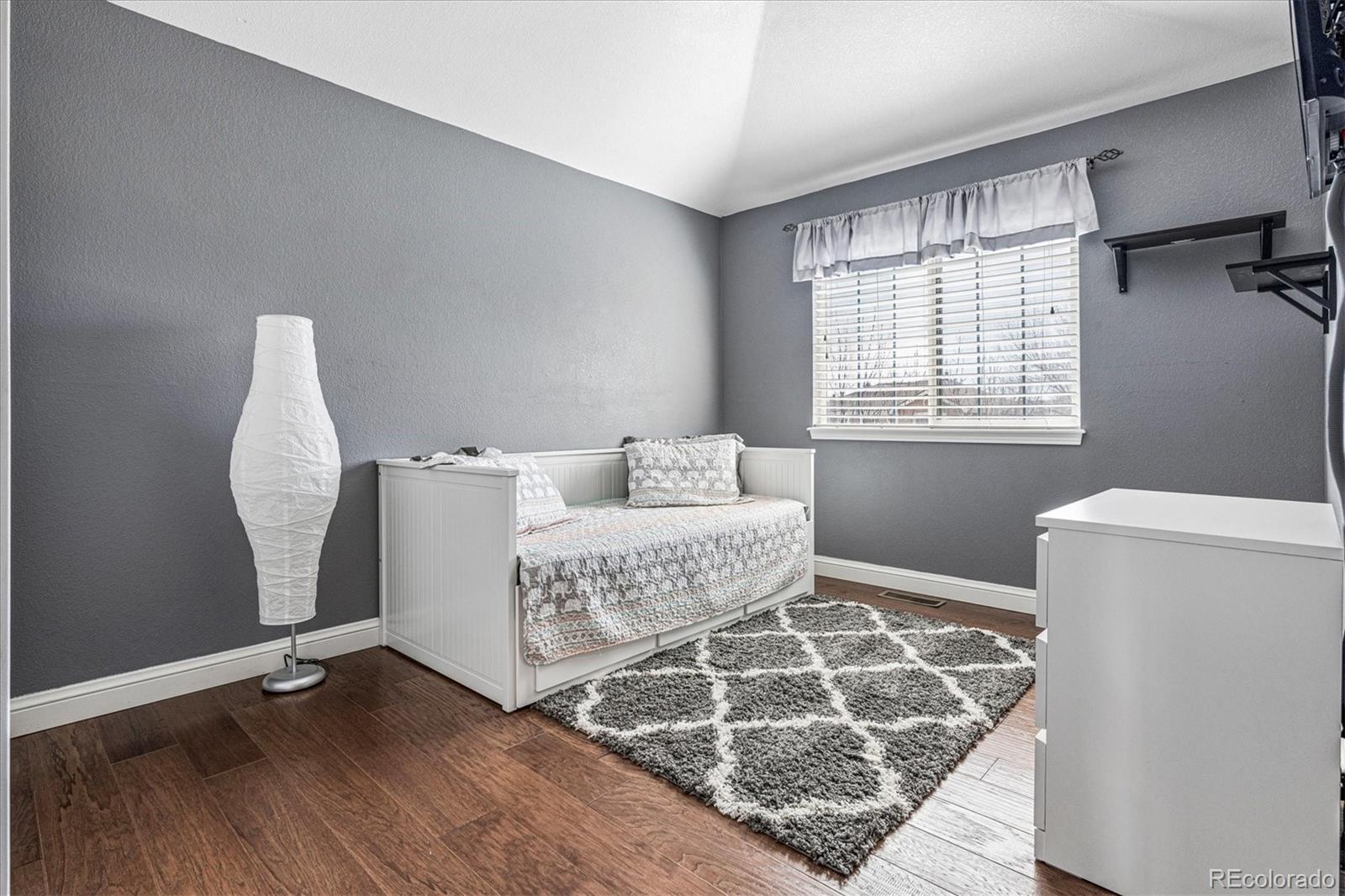 4597 Whitehall Lane Highlands Ranch, CO 80126 - Photo 33 of 50 a living room with a couch and a table