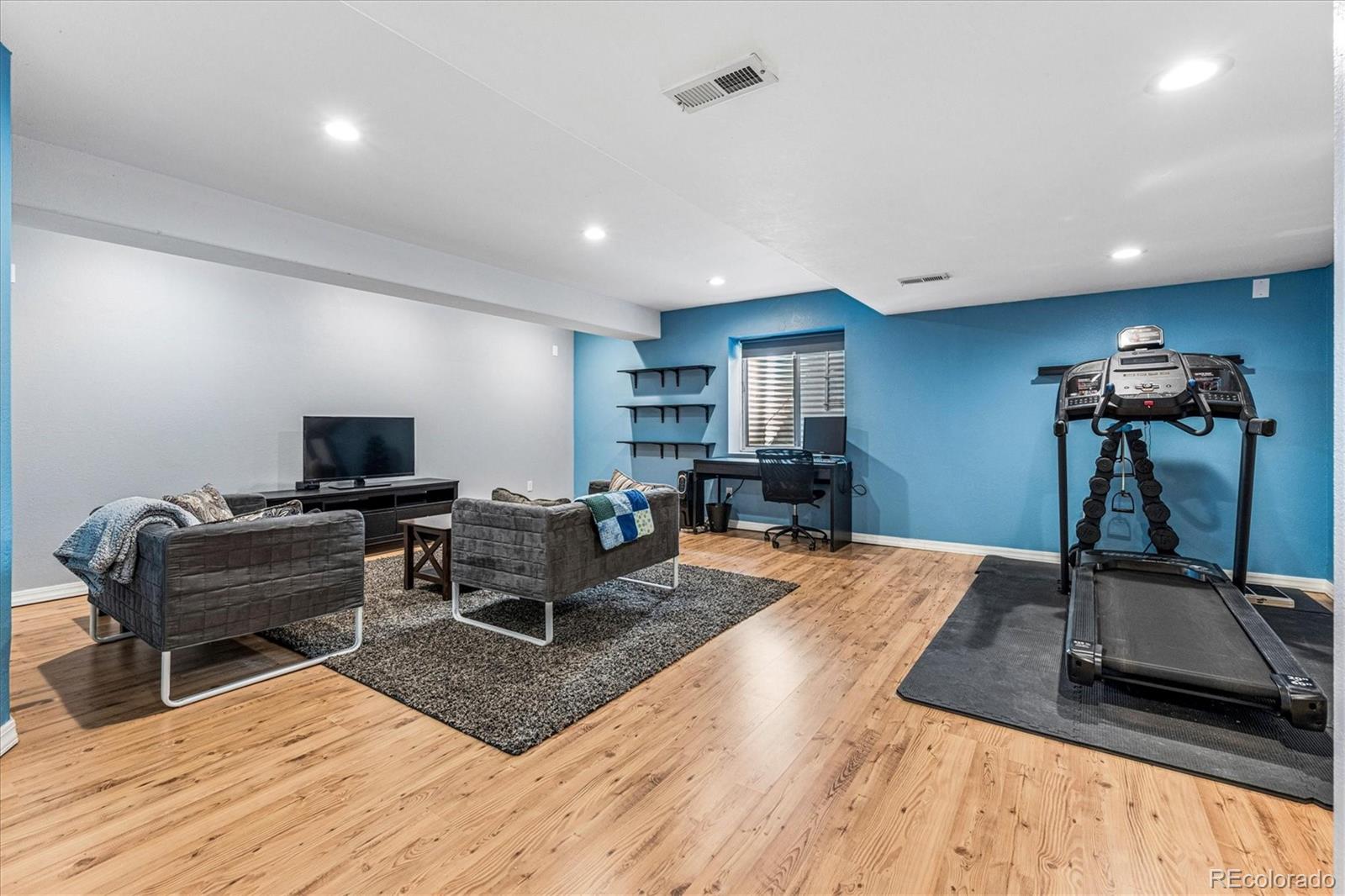 4597 Whitehall Lane Highlands Ranch, CO 80126 - Photo 36 of 50 a living room with furniture and a wooden floor