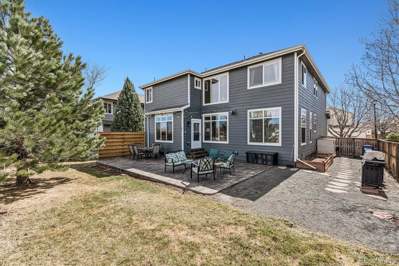 4597 Whitehall Lane Highlands Ranch, CO 80126 - Photo 39 of 50 a backyard of a house with table and chairs