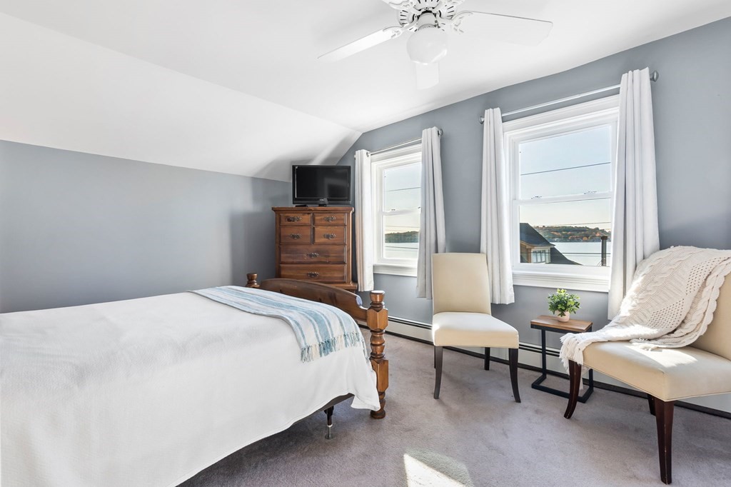 43 Birchmeadow Road Amesbury, MA 01913 - Photo 24 of 39 a bedroom with a bed and a chair