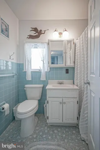 a view of a hallway with entryway wooden floor and front door